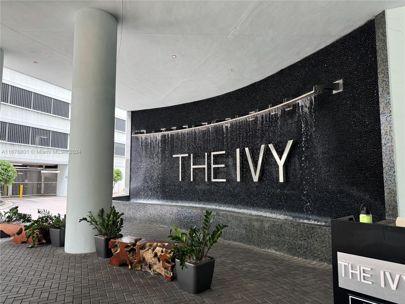 a building with potted plants in front of door