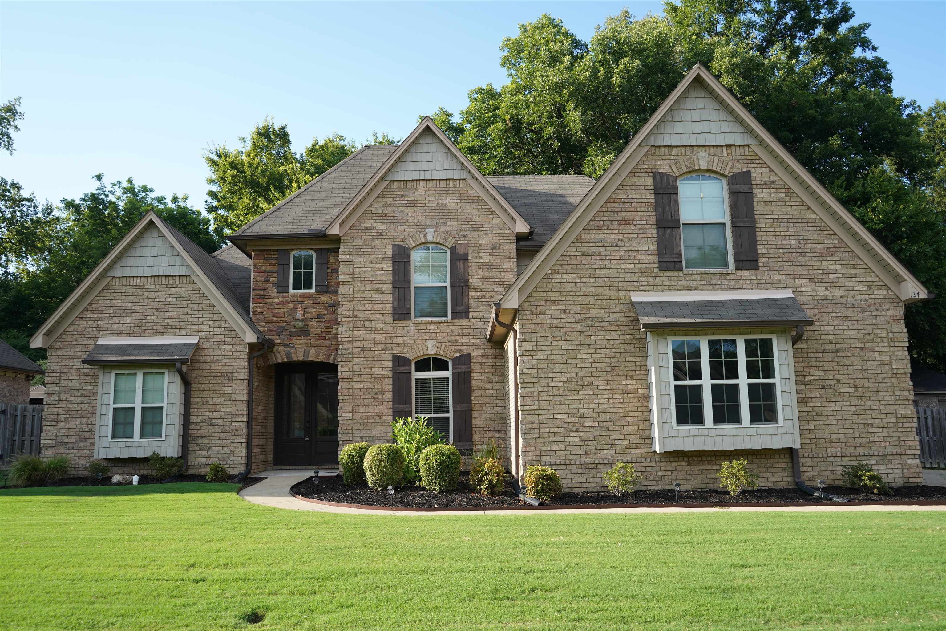 a front view of a house with a yard