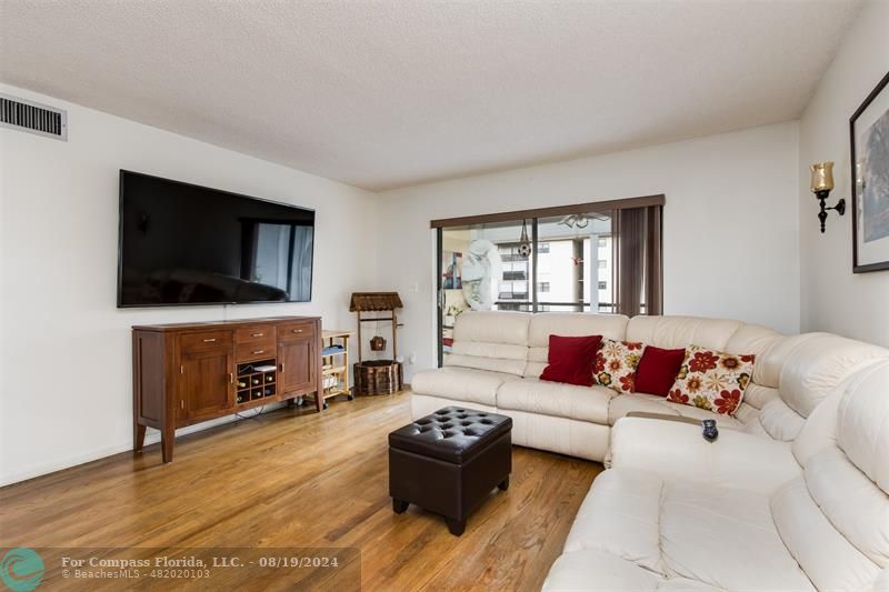 a living room with furniture flat screen tv and a fireplace