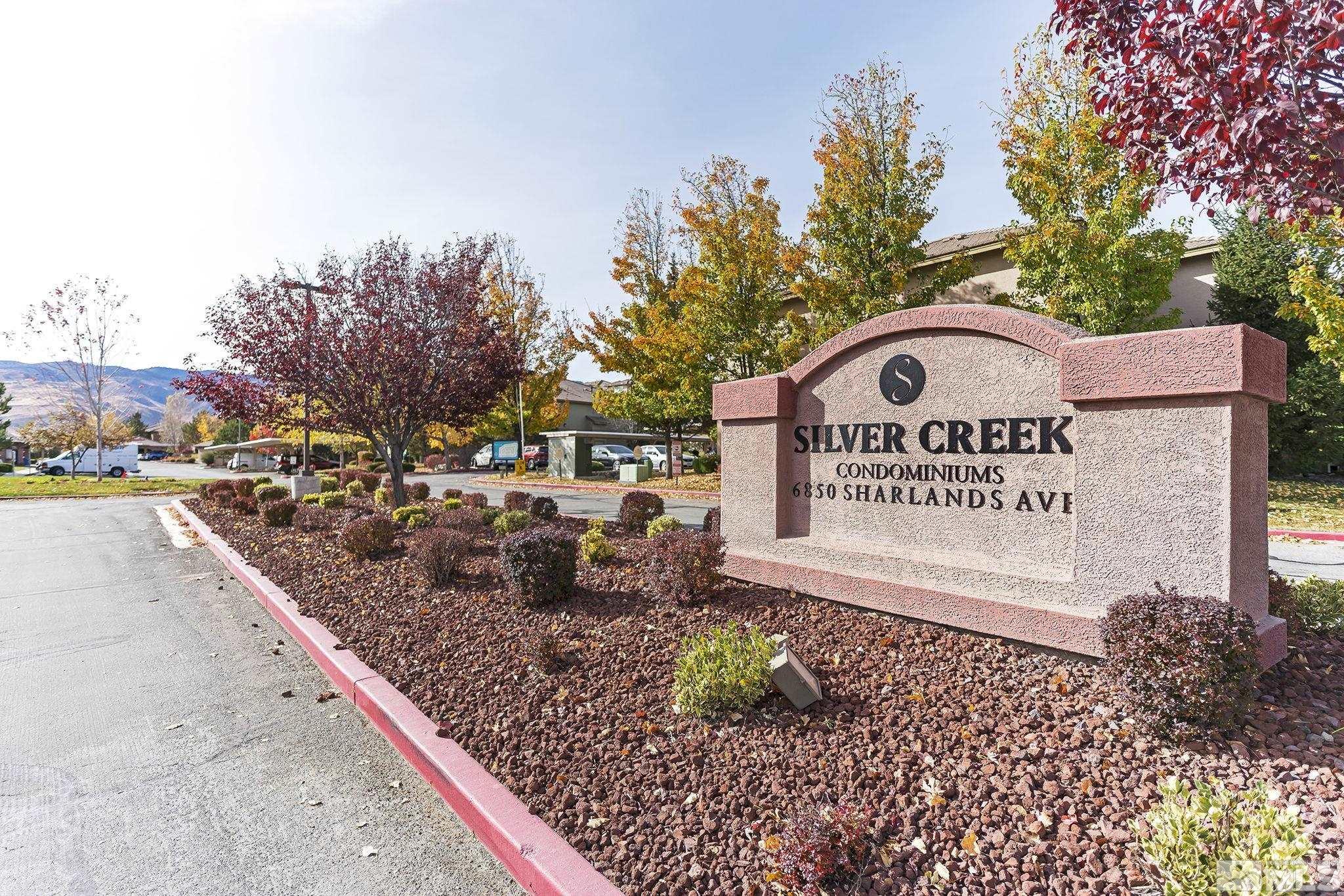 a view of a park that has a sign board