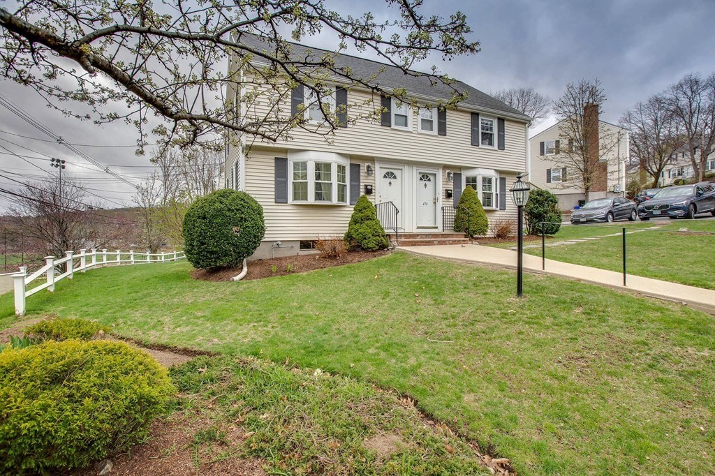 a view of a house with a yard and tree s