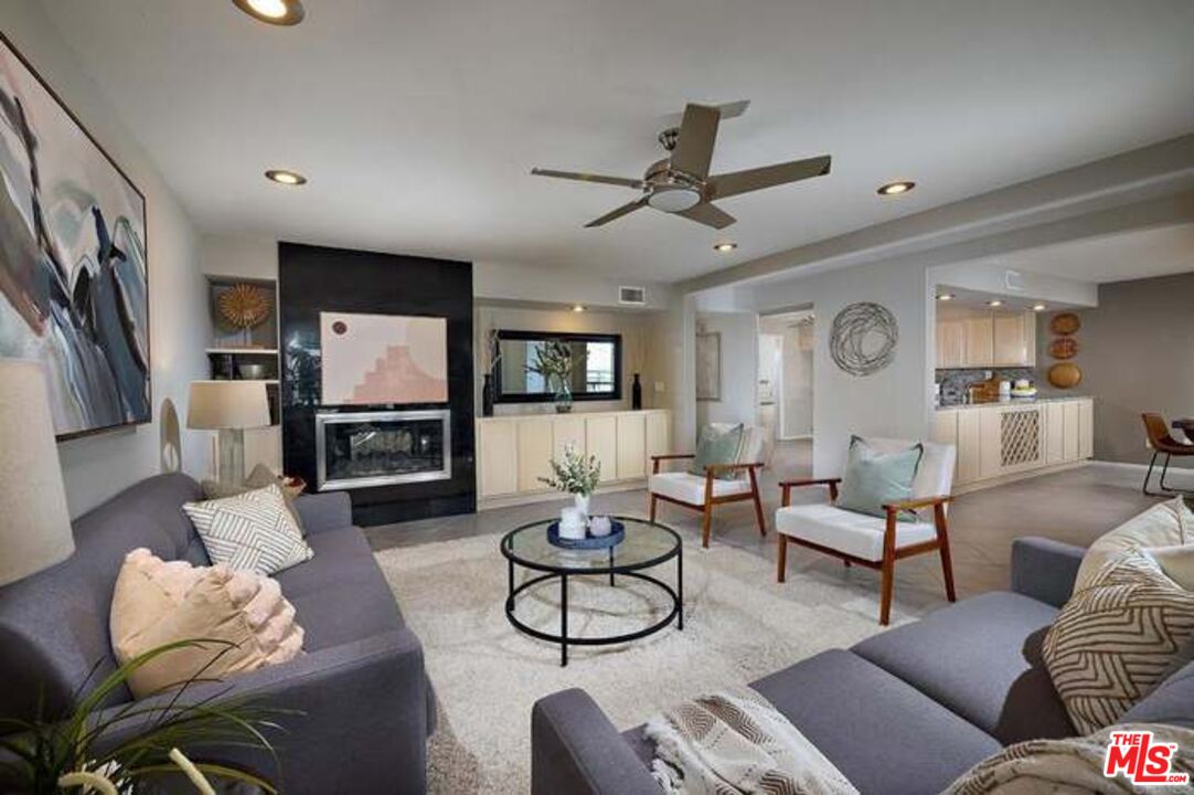 a living room with furniture a rug and a flat screen tv