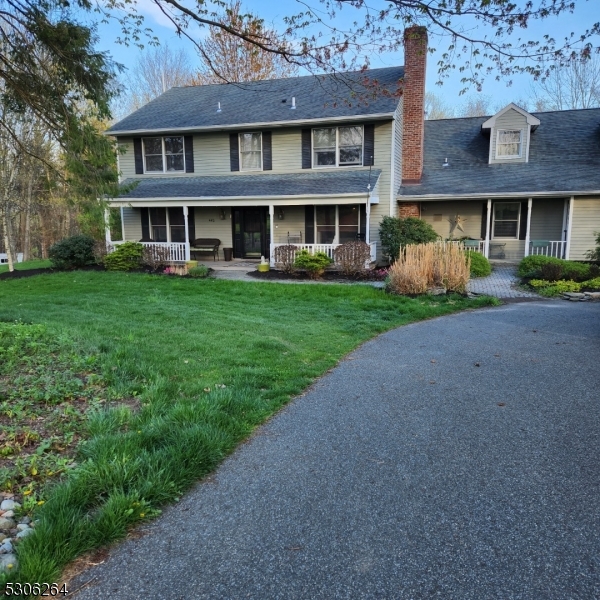 front view of a brick house with a yard