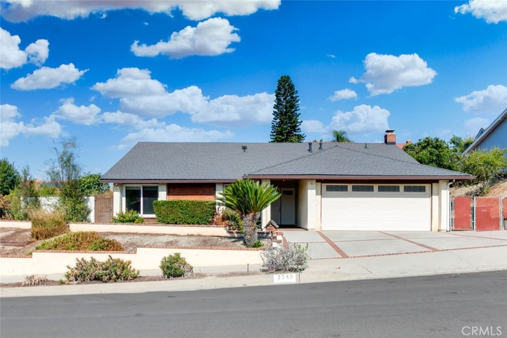 a front view of a house with a yard and a garage