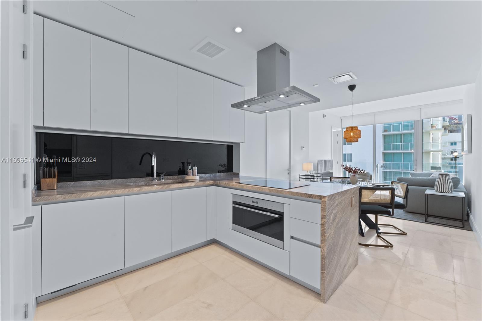 a kitchen with stainless steel appliances granite countertop a sink and a stove