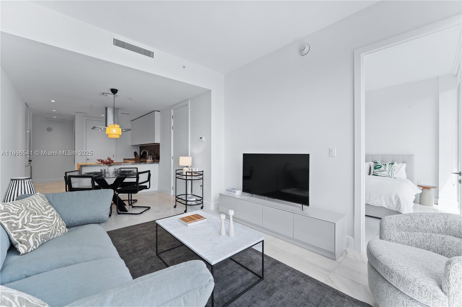 a living room with furniture and a flat screen tv