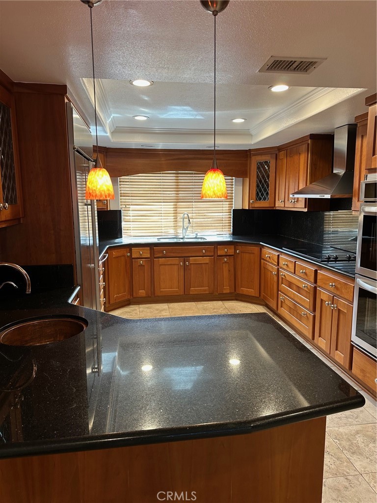 a view of a kitchen with a sink and chandelier