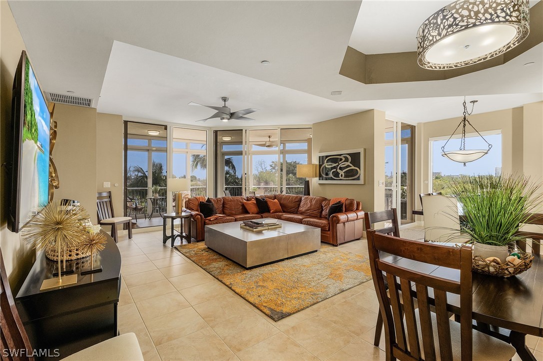 a living room with furniture and a chandelier