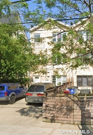 a view of a cars park in front of a building