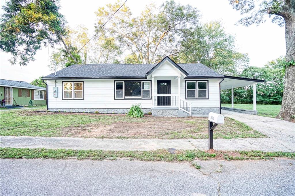 a front view of a house with a garden and yard