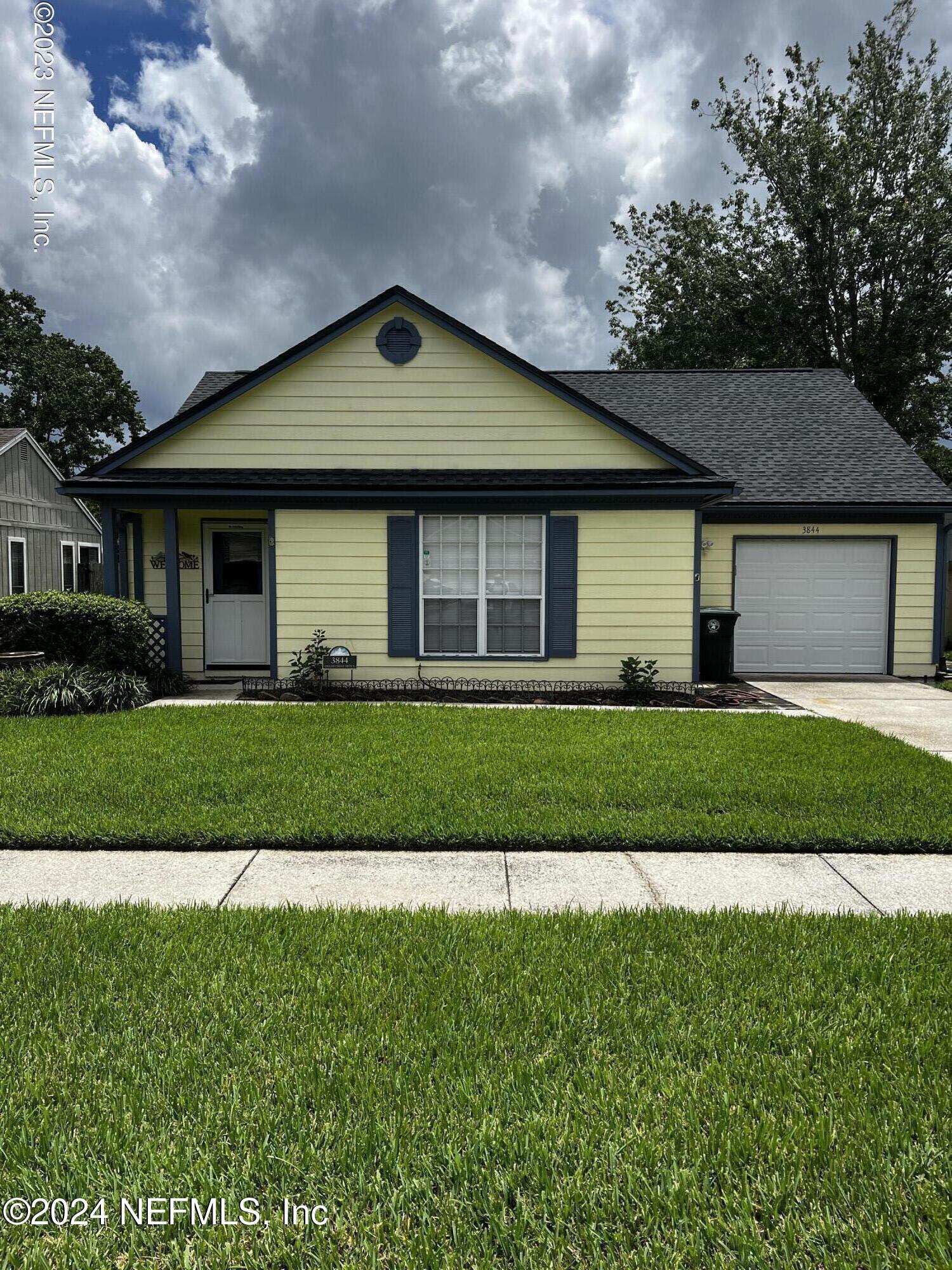 a front view of a house with a garden