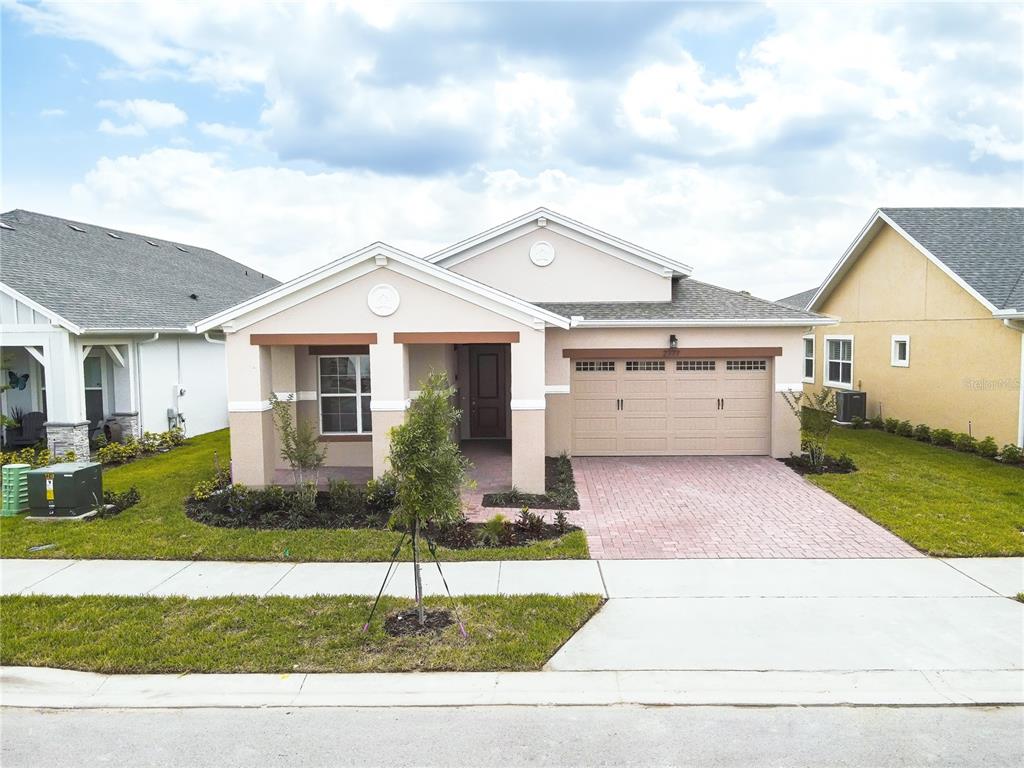 a front view of a house with a yard and garage