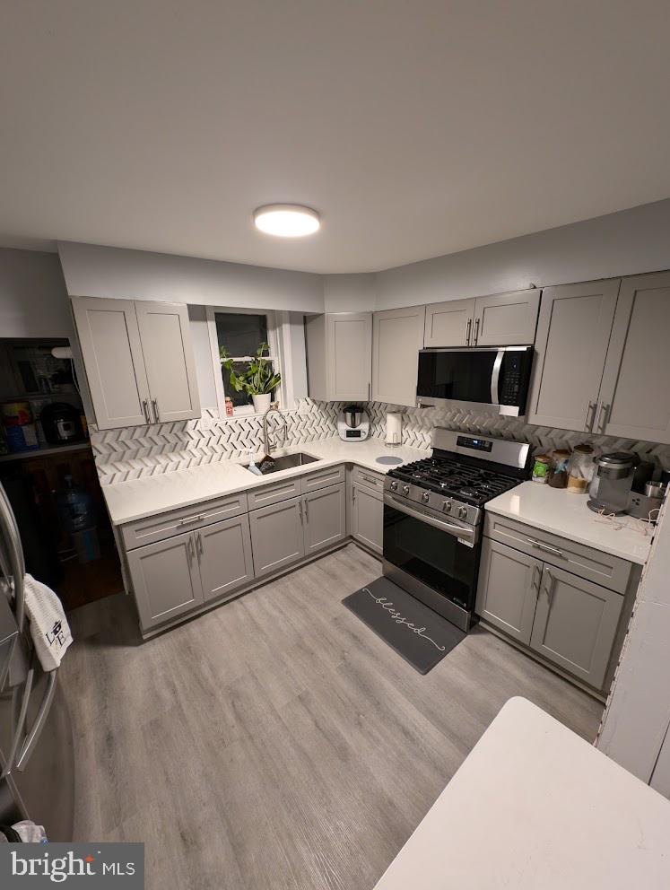 a kitchen with a stove a sink and a refrigerator