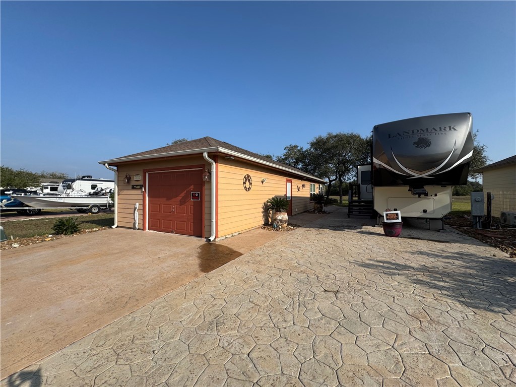 a view of garage and car parked