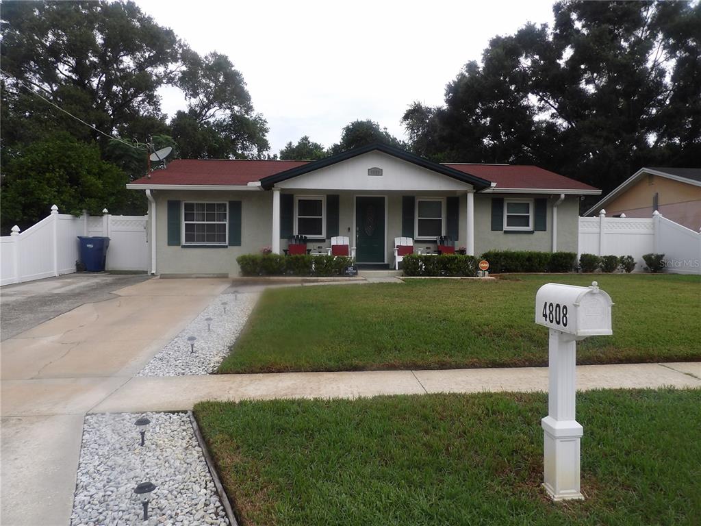 a front view of a house with a yard fire pit and outdoor seating