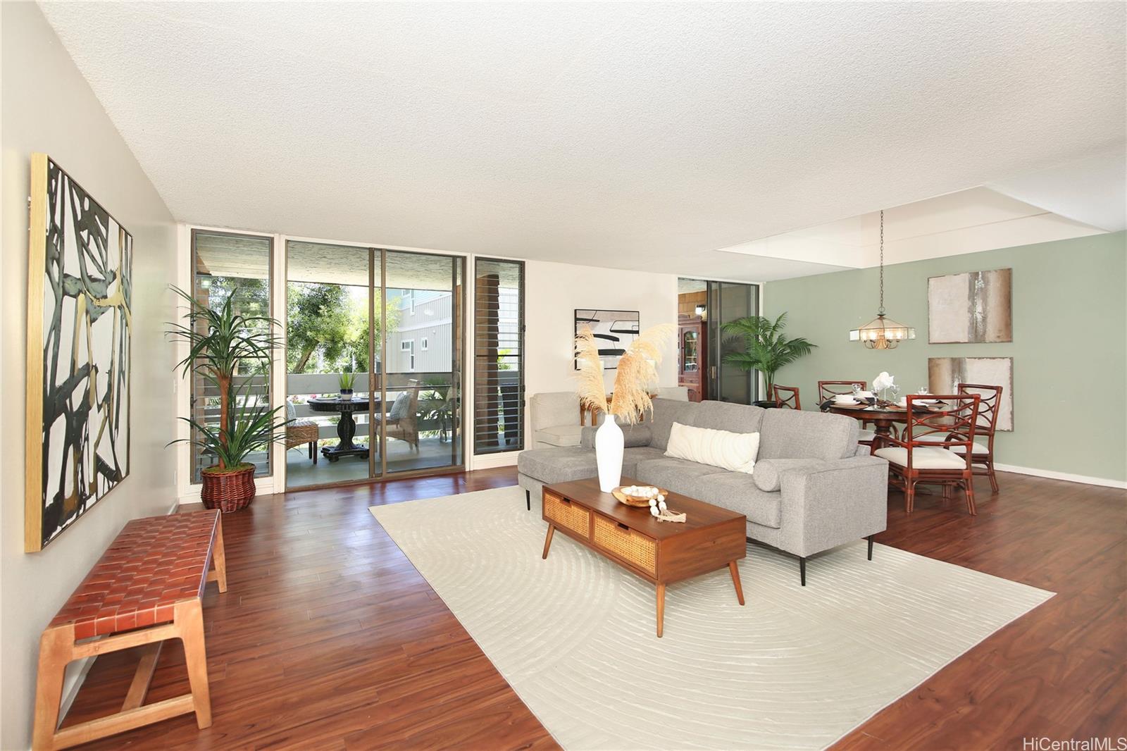 a living room with furniture and a wooden floor