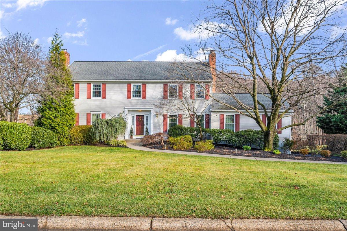 a front view of house with yard and green space