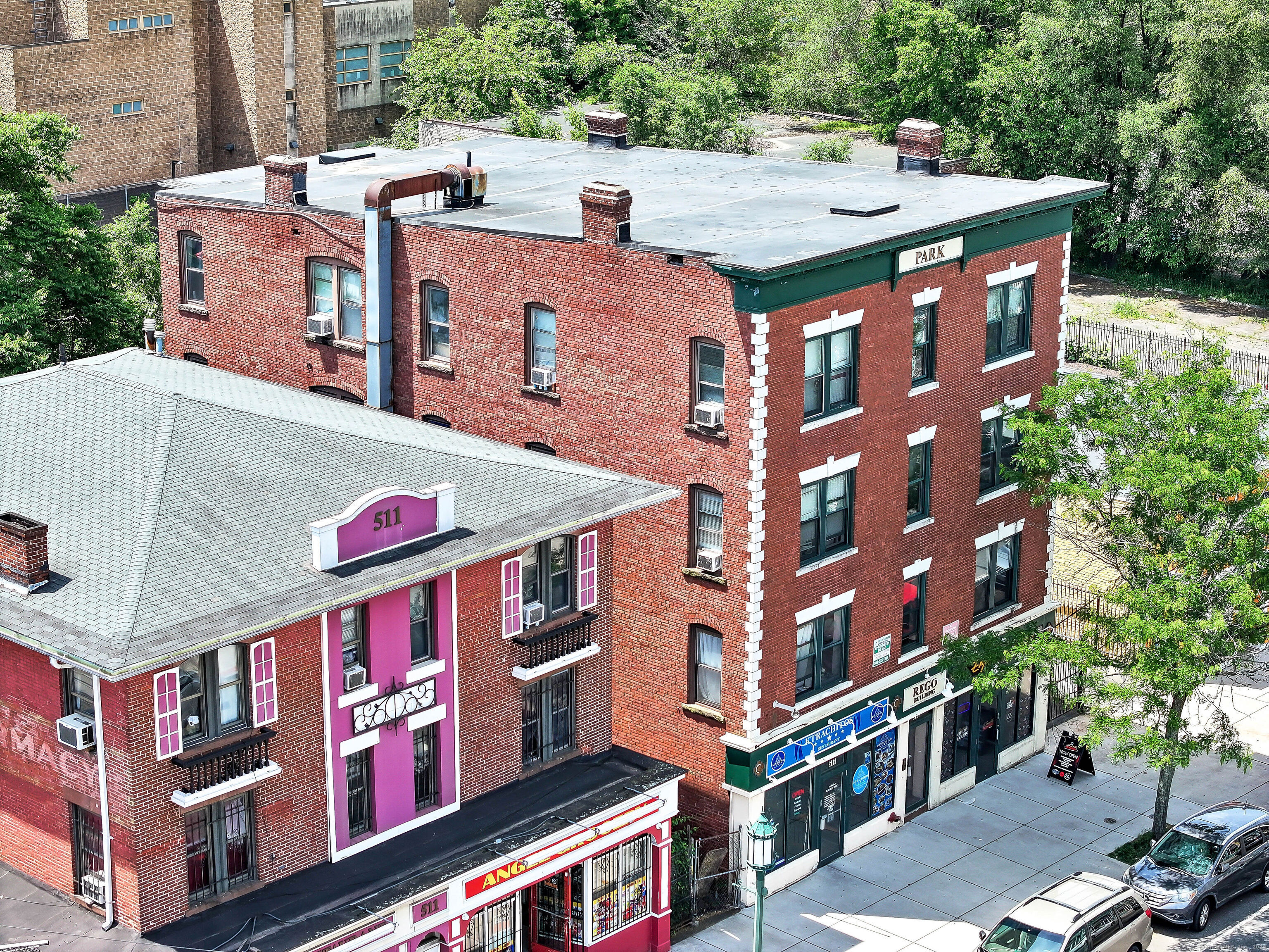 a aerial view of multi story residential apartment building with a yard