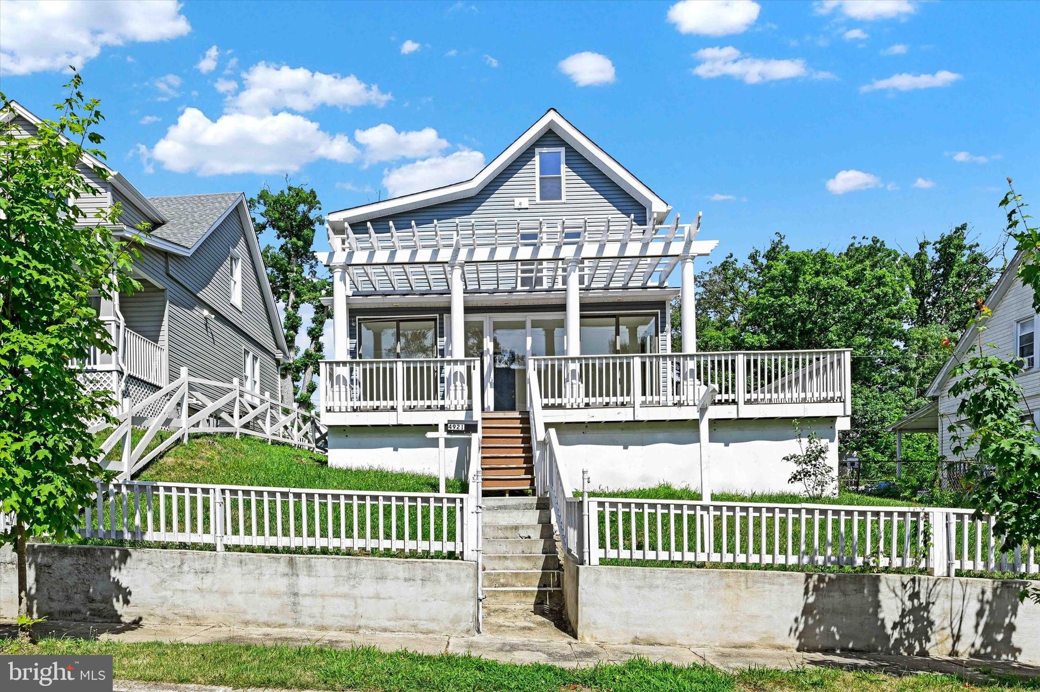 a front view of a house with a garden