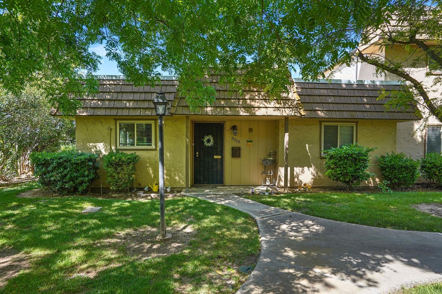 a front view of a house with a yard