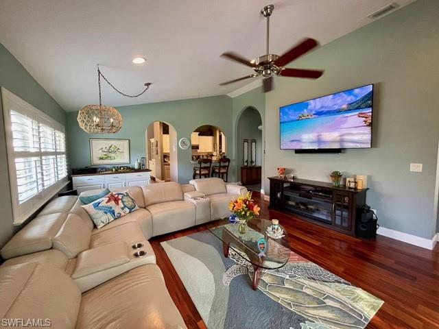 a living room with furniture flat screen tv and wall paintings