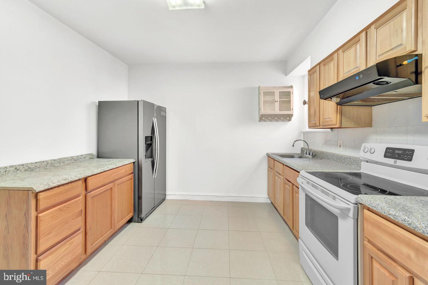 a kitchen with stainless steel appliances granite countertop a sink and a stove top oven