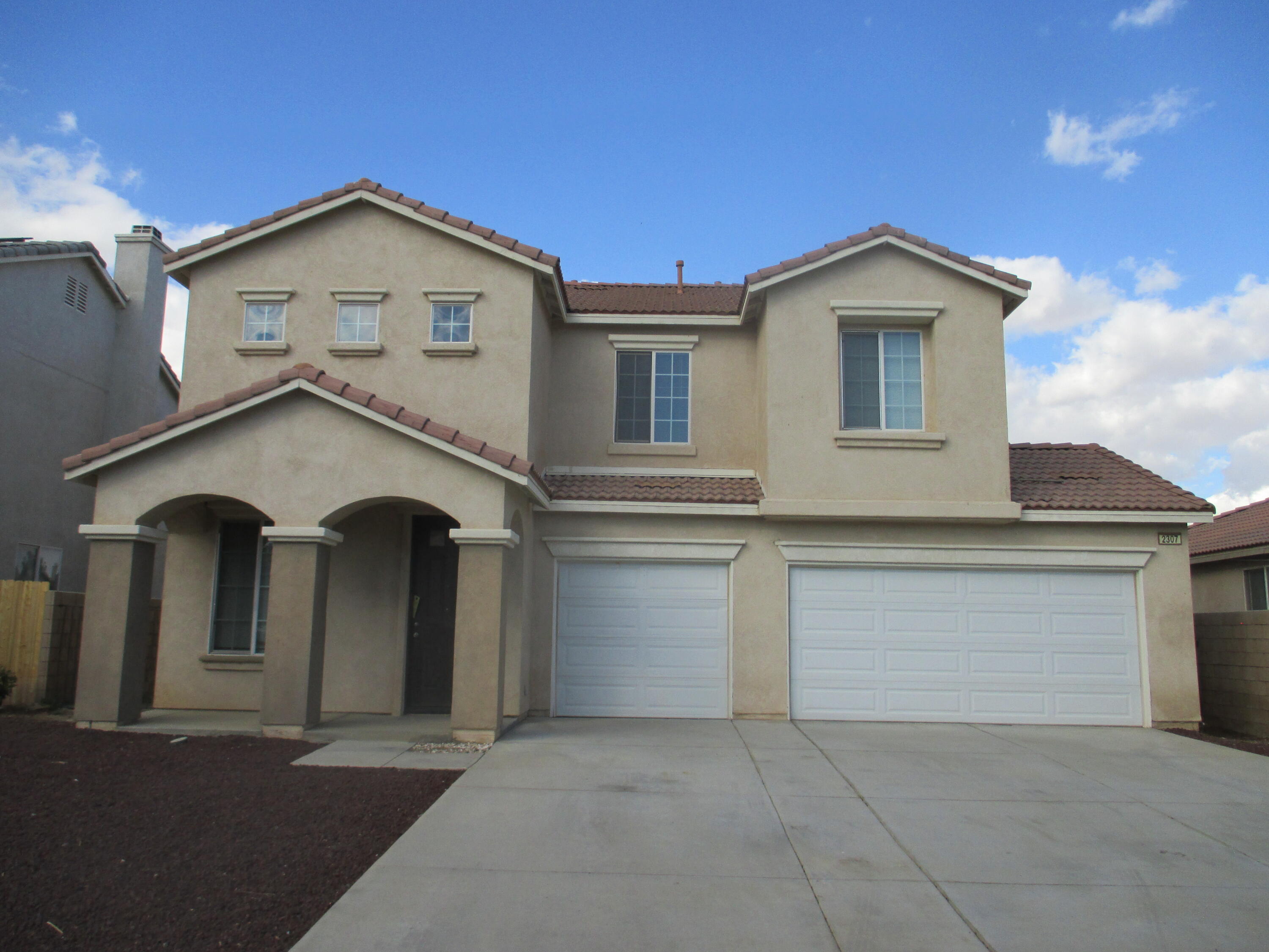 a front view of a house with a garage