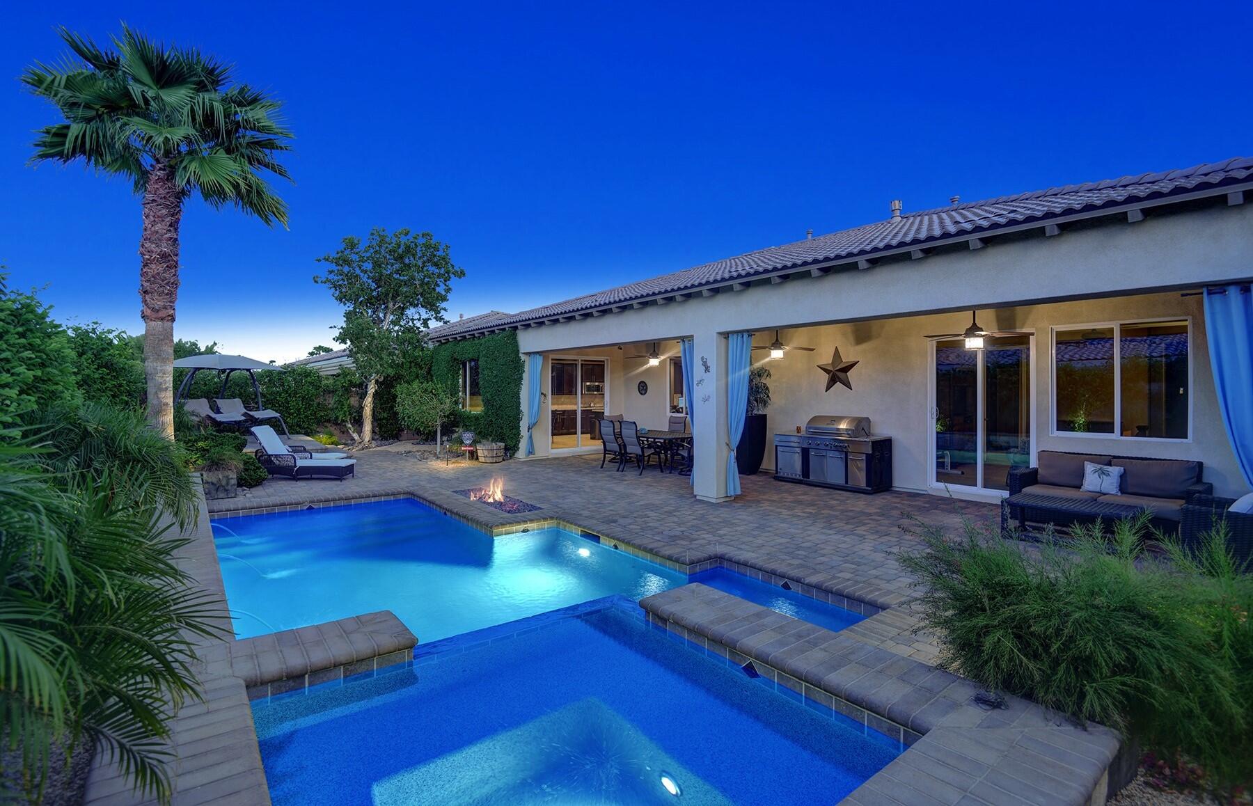 a view of a house with swimming pool and sitting area