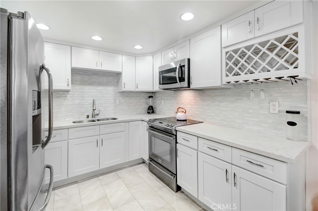 a kitchen with stainless steel appliances granite countertop a sink and a stove