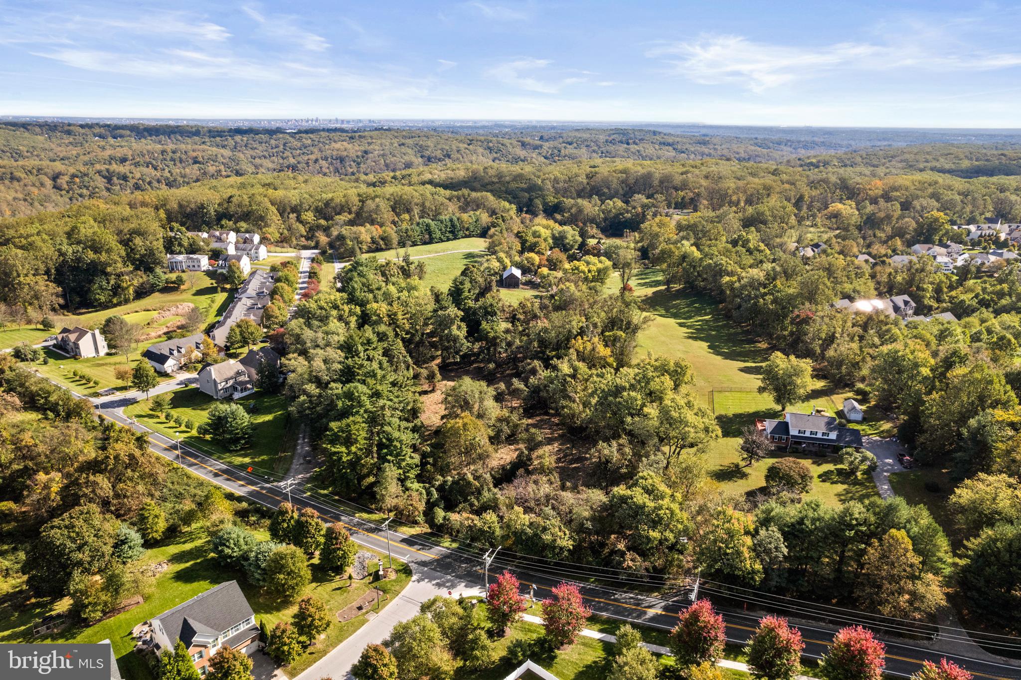 an aerial view of residential house with yard and mountain view in back