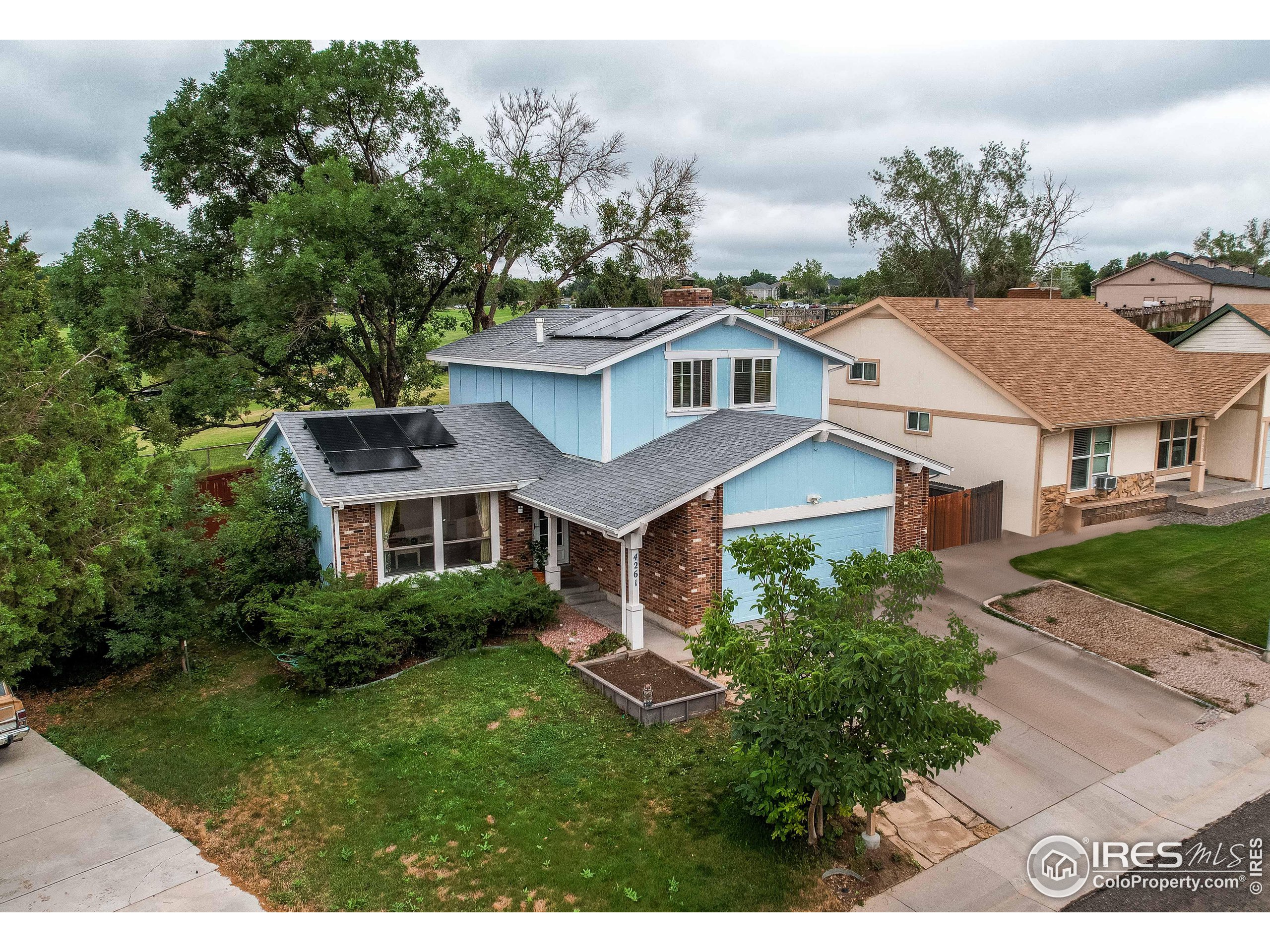 a aerial view of a house with a yard