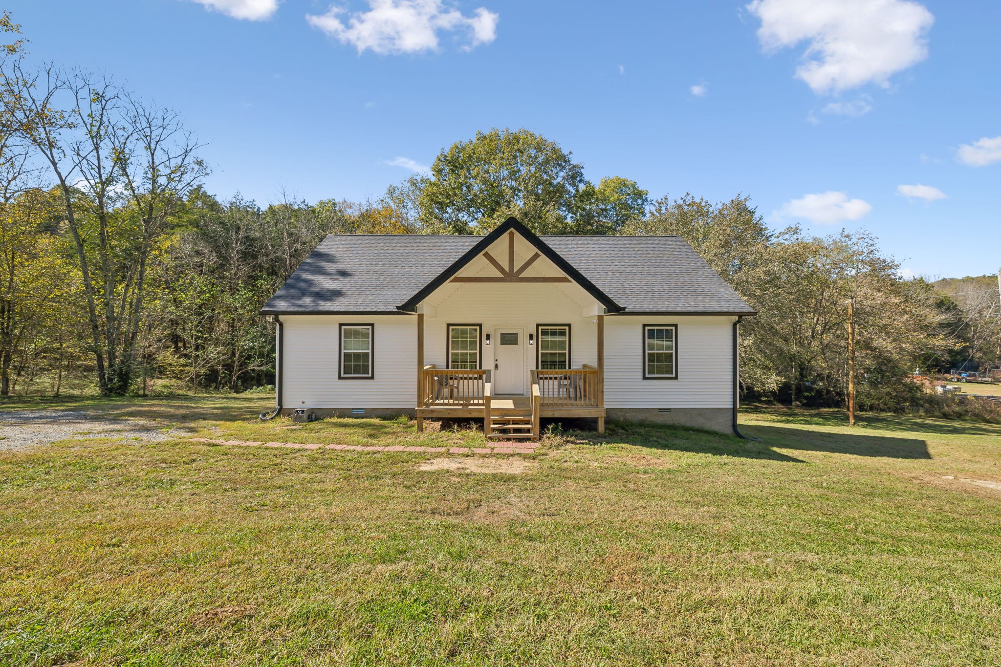 a view of a house with yard and sitting area