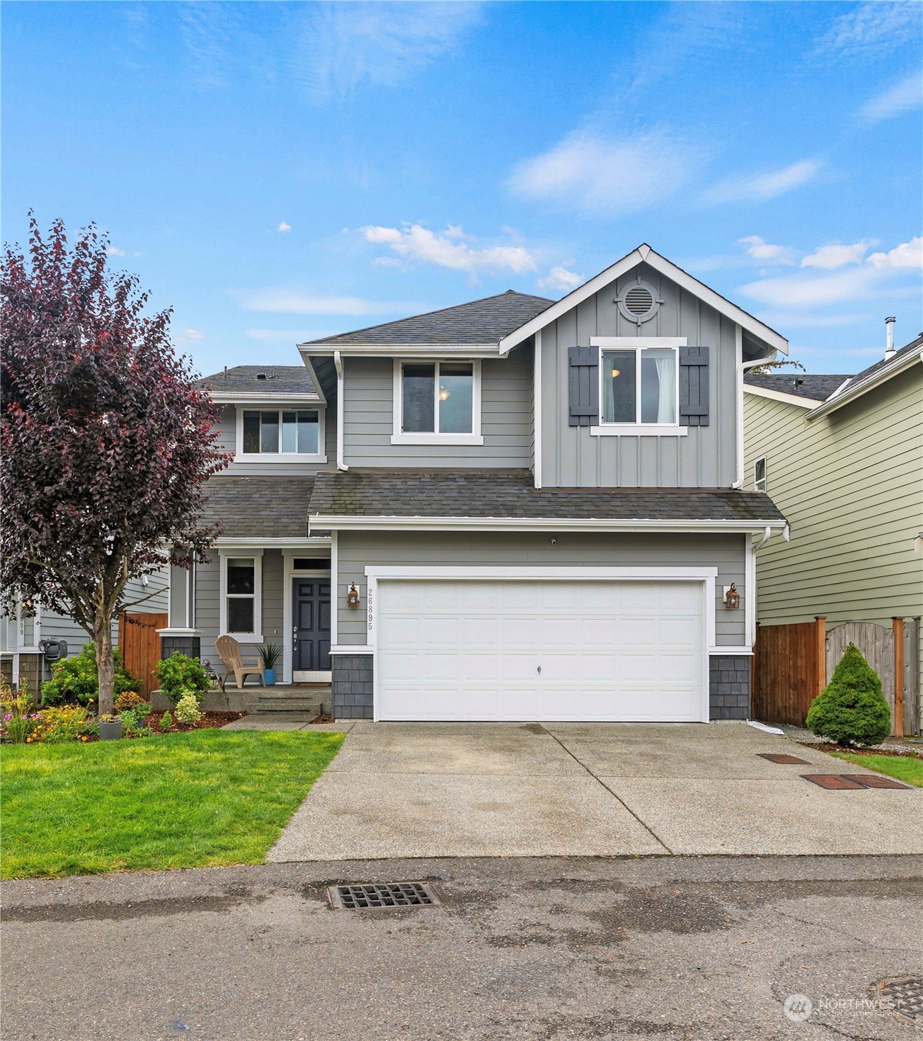 a front view of a house with a yard and garage