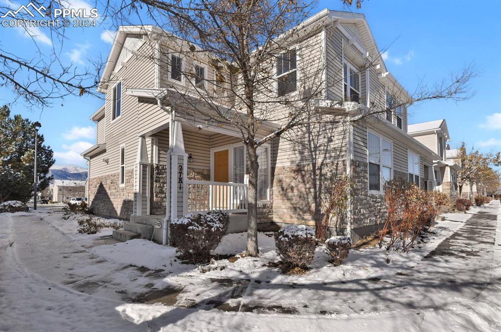 View of snow covered exterior with a porch