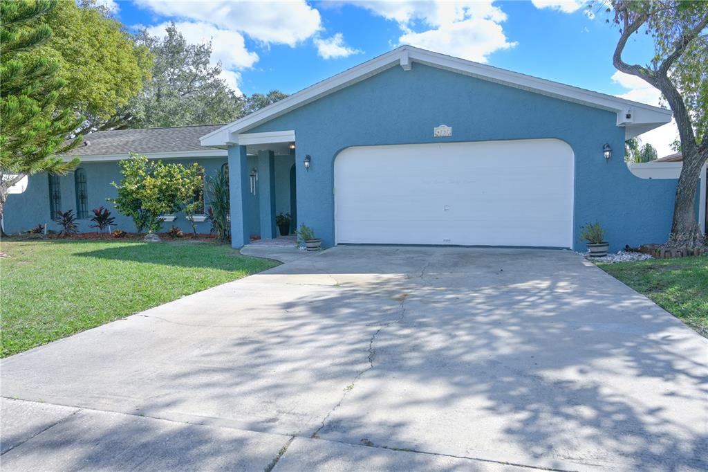 a front view of a house with a yard and garage