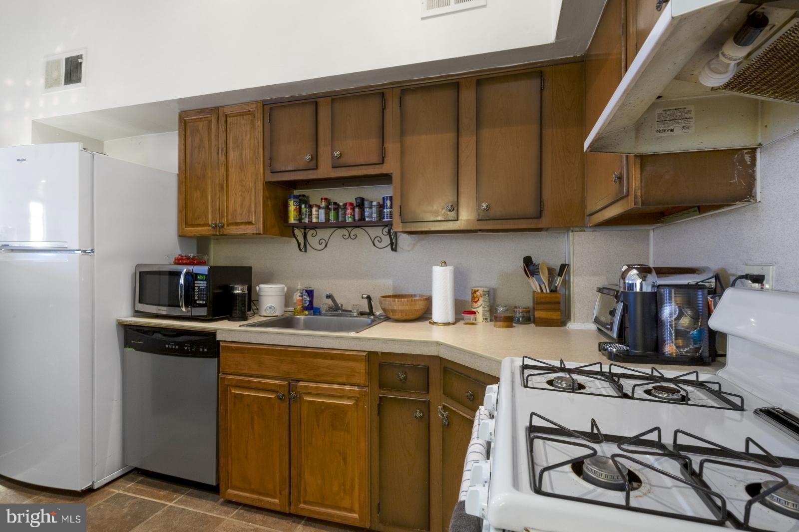 a kitchen with a sink a stove and cabinets