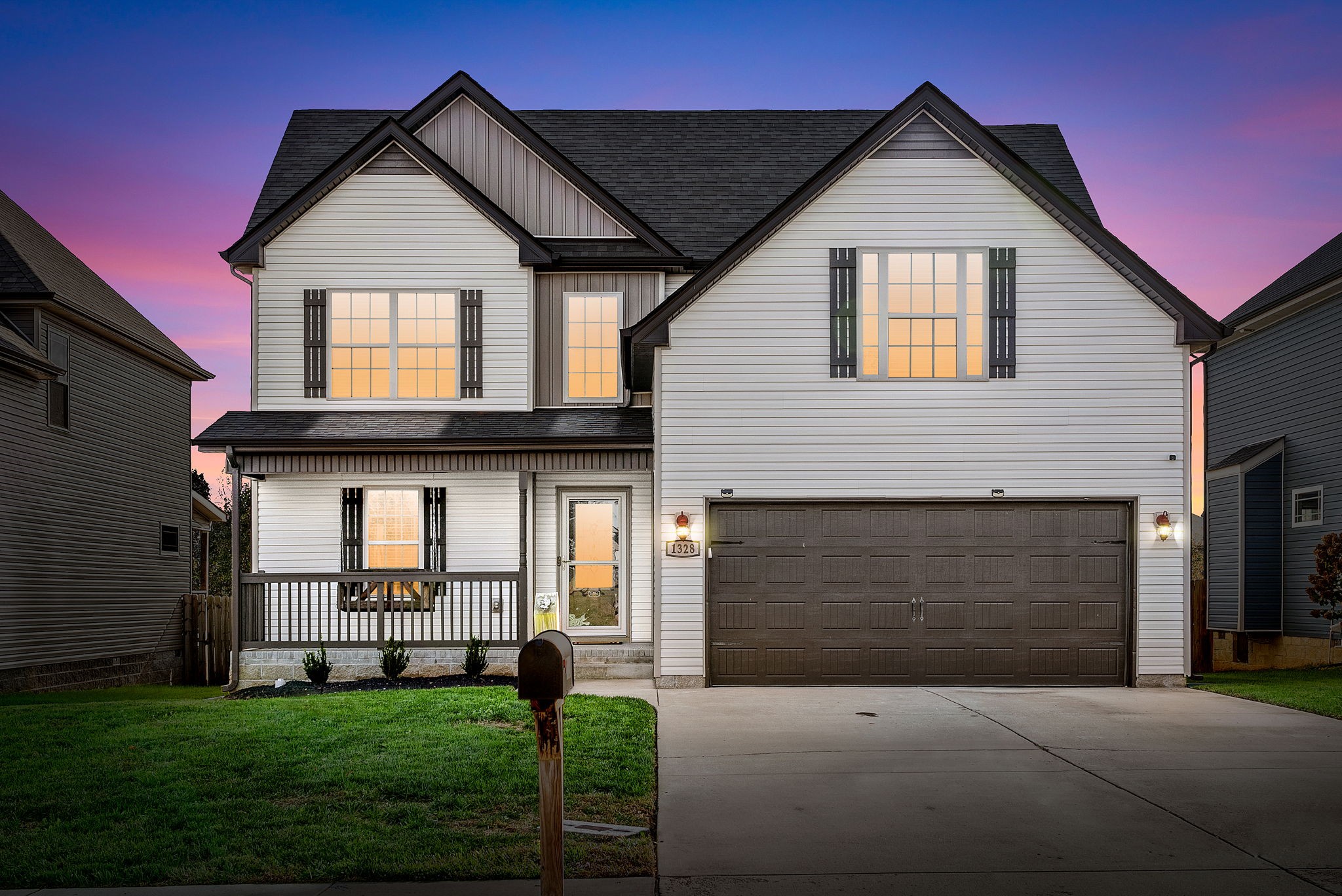 a front view of a house with a yard and garage