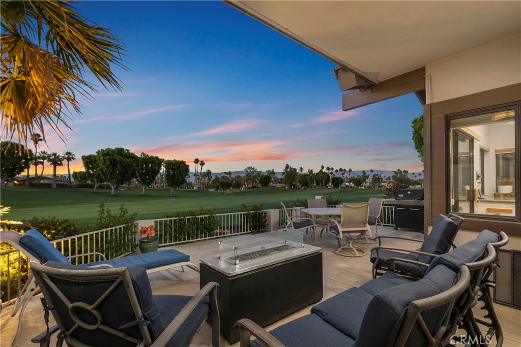 a view of a terrace with couches and city view