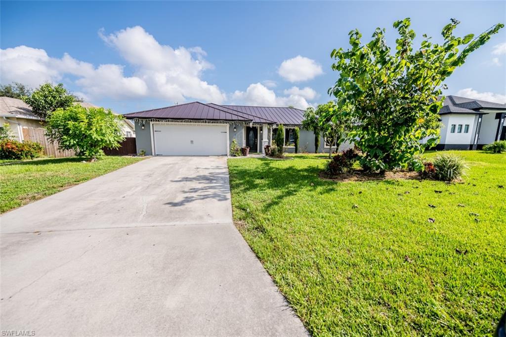 Ranch-style home with a garage and a front yard