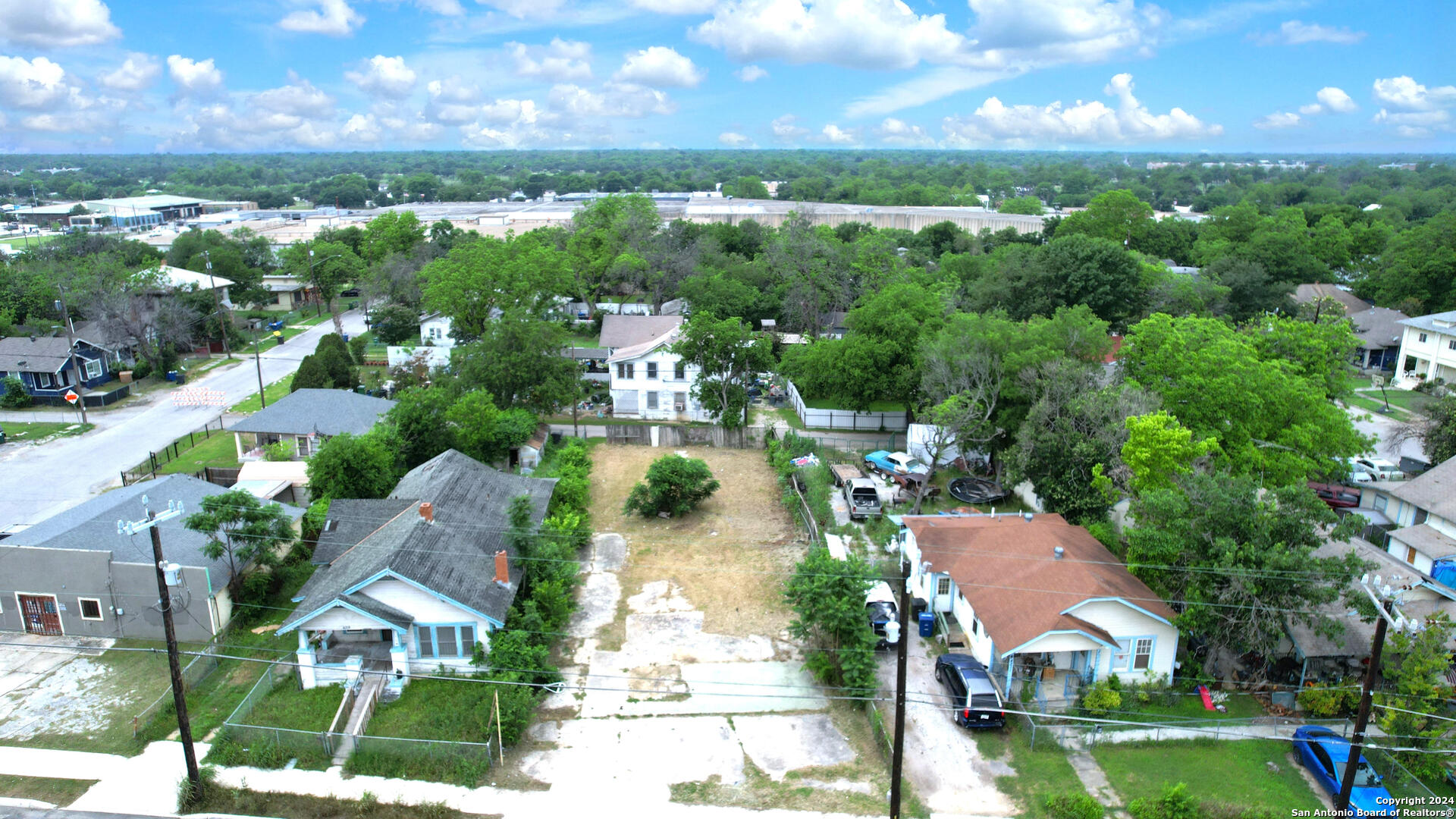 an aerial view of residential houses with outdoor space and lake view