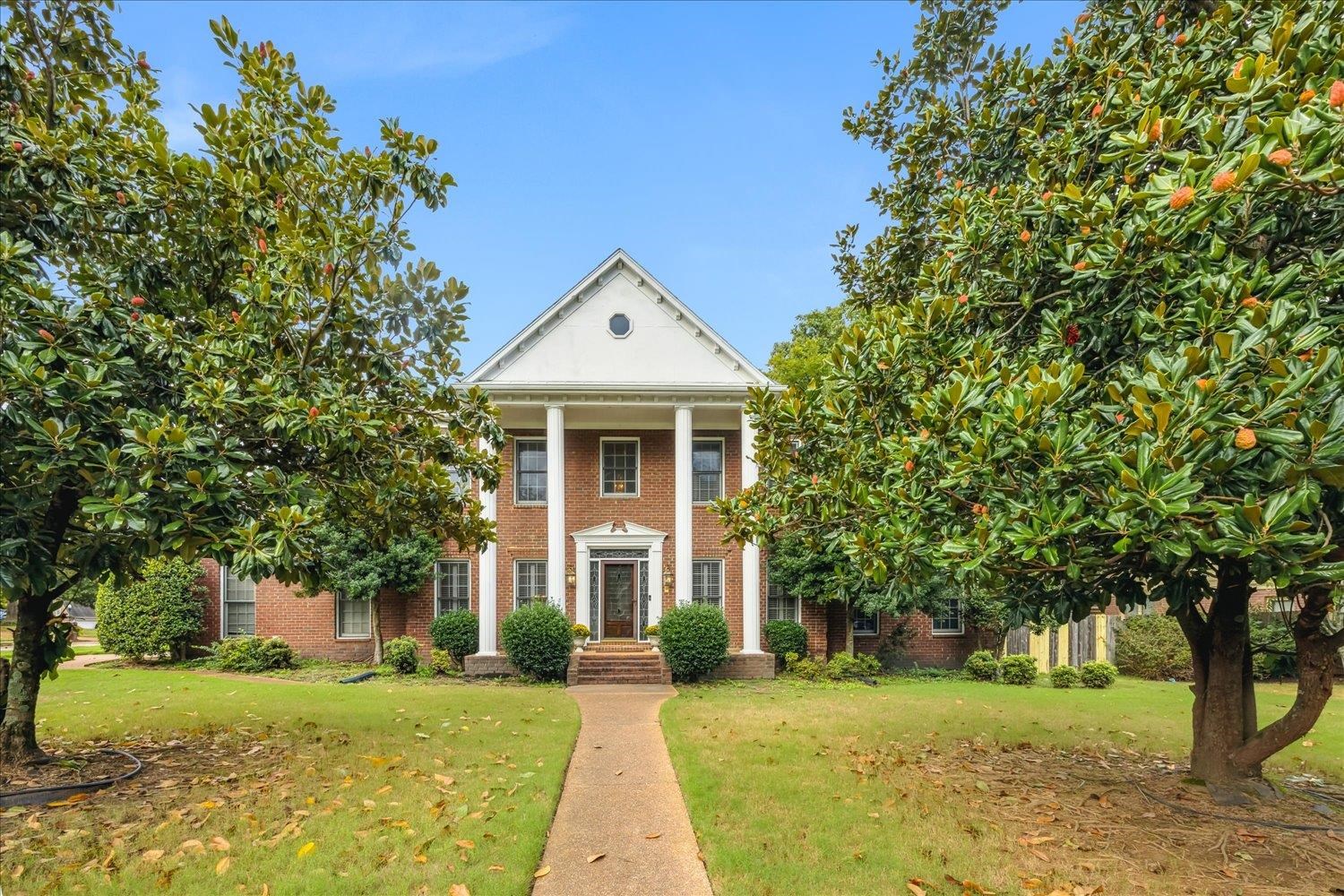 Neoclassical / greek revival house with a front lawn