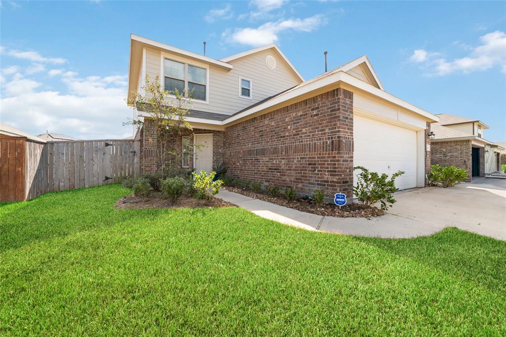 a view of a house with a yard and pathway