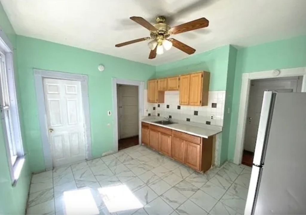 a kitchen with stainless steel appliances a sink and a refrigerator