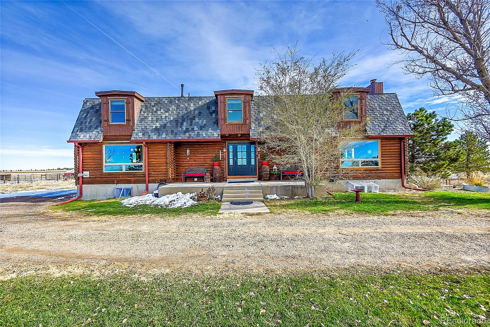 a view of house with outdoor space and parking