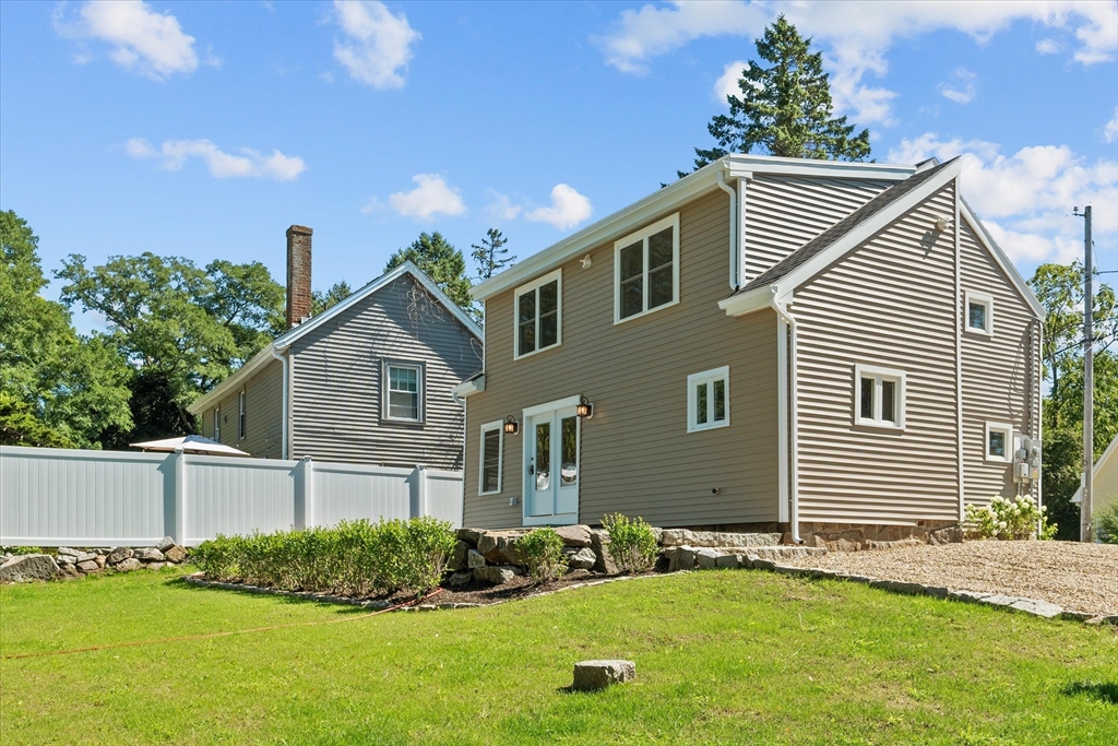 a view of backyard of house with green space