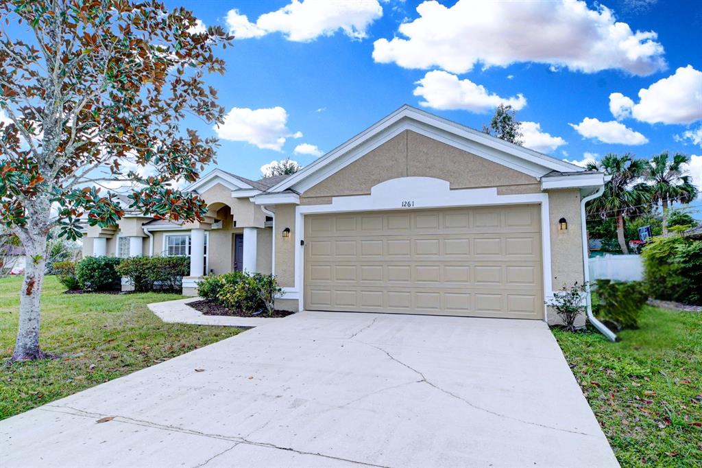 a front view of a house with a yard and garage