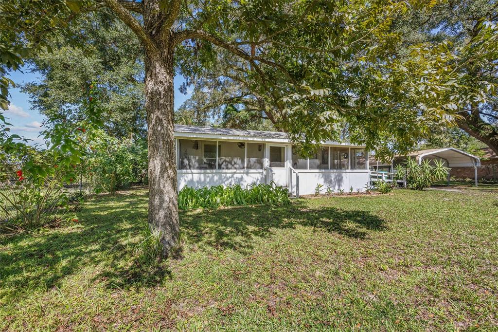 a view of a house with backyard sitting area and garden