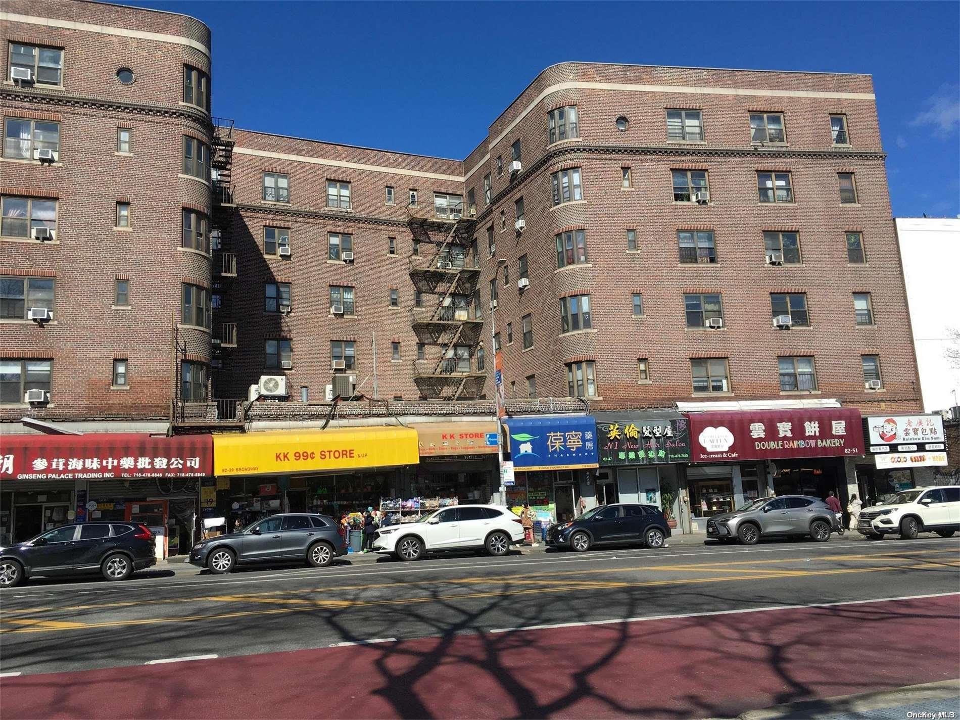 a front view of multi story building with retail shops