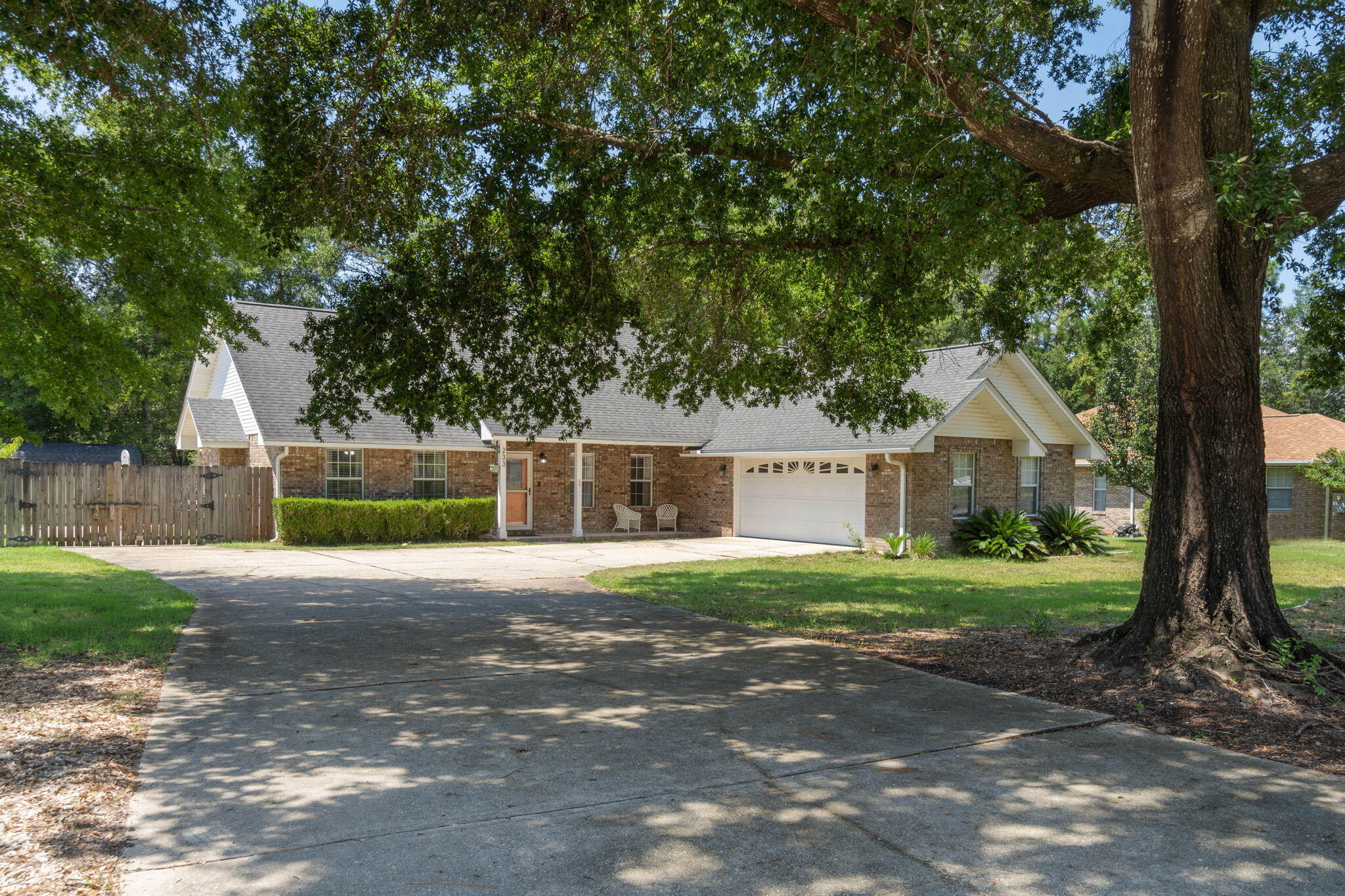 a front view of a house with a yard and trees