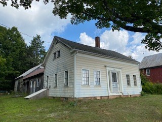 a front view of house with a garden